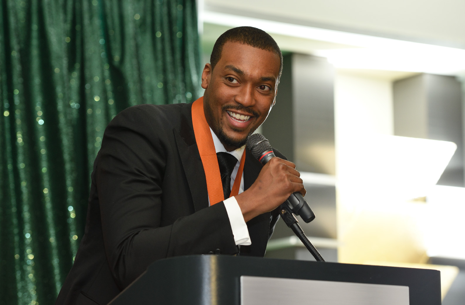 Man speaking on stage at an event